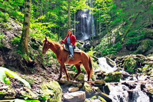 Riding to a mountain waterfall 