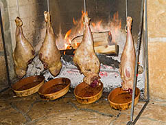 Deer Valley legs of lamb roasting in fireplace